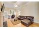 Inviting living room featuring hardwood floors, a fireplace, neutral paint, and a leather sectional sofa at 589 Cook Dr, Ellenwood, GA 30294