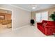 A versatile living space with a red sofa, office chair, and an open doorway to another room at 589 Cook Dr, Ellenwood, GA 30294