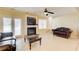 Comfortable living room with fireplace, TV, tile floor, and a stylish leather couch at 589 Cook Dr, Ellenwood, GA 30294
