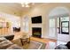 Cozy living room featuring a fireplace, hardwood floors, and access to a screened porch at 589 Cook Dr, Ellenwood, GA 30294