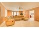 A cozy living room features a plush sectional sofa, a ceiling fan, and large windows for natural light at 589 Cook Dr, Ellenwood, GA 30294