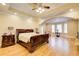 Large main bedroom with hardwood floors, a tray ceiling, and natural light from the windows at 589 Cook Dr, Ellenwood, GA 30294
