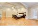 Large main bedroom with hardwood floors, a tray ceiling, and natural light from the windows at 589 Cook Dr, Ellenwood, GA 30294