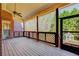 Inviting screened porch offering views of a serene backyard with mature trees at 589 Cook Dr, Ellenwood, GA 30294