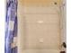 Clean white tiled shower with bronze fixtures and a decorative shower curtain at 589 Cook Dr, Ellenwood, GA 30294