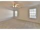 Spacious main bedroom with a ceiling fan and lots of natural light at 714 Village Ln, Loganville, GA 30052