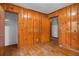 Wood paneled bedroom with hardwood floors and multiple doors at 1678 Capistrana Pl, Decatur, GA 30032