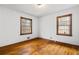 A bedroom with wood floors and two windows with dark trim at 1678 Capistrana Pl, Decatur, GA 30032