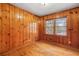 Wood paneled bedroom with hardwood floors and a large window at 1678 Capistrana Pl, Decatur, GA 30032