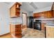 A kitchen featuring wood cabinets, a breakfast bar, and a black gas range at 1678 Capistrana Pl, Decatur, GA 30032