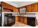 A kitchen featuring wood cabinets, and a black gas range at 1678 Capistrana Pl, Decatur, GA 30032