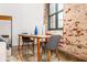 Dining area features a table with chairs next to exposed brick and a large window at 170 Boulevard Se # H416, Atlanta, GA 30312