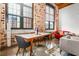 Cozy dining area with exposed brick and a large window at 170 Boulevard Se # H416, Atlanta, GA 30312