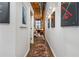 Hallway with artwork on walls and view of living space in renovated brick mill at 170 Boulevard Se # H416, Atlanta, GA 30312