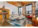 Open living room featuring exposed brick, high ceilings, and modern decor at 170 Boulevard Se # H416, Atlanta, GA 30312