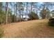 Expansive backyard with mature trees offers privacy and ample space for outdoor activities at 2142 Graystone Pkwy, Grayson, GA 30017