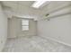 Finished basement with gray carpet, drywall walls, and a window providing natural light at 2142 Graystone Pkwy, Grayson, GA 30017