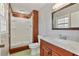 Traditional bathroom featuring a step-in shower, single sink vanity with hard surface countertop, and wood trim at 2142 Graystone Pkwy, Grayson, GA 30017