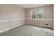 Neutral bedroom with grey carpet, white trim and baseboards and a double-hung window at 2142 Graystone Pkwy, Grayson, GA 30017