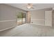 Spacious bedroom with a ceiling fan and sliding doors leading to an outdoor deck for relaxation and enjoyment at 2142 Graystone Pkwy, Grayson, GA 30017