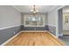 Bright dining room featuring hardwood floors, chair rail detail, and a stylish chandelier fixture at 2142 Graystone Pkwy, Grayson, GA 30017