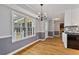 Dining room featuring hardwood floors, chandelier, and large windows providing natural light at 2142 Graystone Pkwy, Grayson, GA 30017