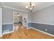 Elegant dining room with hardwood floors, chair rail detail, and open access to the kitchen at 2142 Graystone Pkwy, Grayson, GA 30017