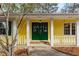 Charming green double front door with sidelights and white columns on a yellow house, offering a warm welcome at 2142 Graystone Pkwy, Grayson, GA 30017