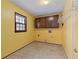 Functional laundry room with tile floor, window, and wall-mounted storage at 2142 Graystone Pkwy, Grayson, GA 30017