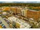 Aerial view of mixed-use development features retail spaces and residential apartments in an urban setting at 2601 Boulder Way, Woodstock, GA 30188