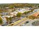 An aerial view captures a bustling small town center with shops, restaurants, and a railway crossing at 2601 Boulder Way, Woodstock, GA 30188