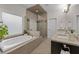 Bathroom featuring a soaking tub, walk-in shower, and double sink vanity at 2601 Boulder Way, Woodstock, GA 30188