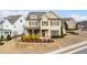 Beautifully landscaped two-story home featuring a welcoming front porch and stone retaining wall at 2601 Boulder Way, Woodstock, GA 30188