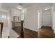 Upstairs hallway showcasing wood floors, white trim and doors, and natural light at 2601 Boulder Way, Woodstock, GA 30188