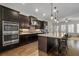 Kitchen with stainless steel double oven and island with bar stool seating at 2601 Boulder Way, Woodstock, GA 30188