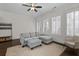 Living room with a gray sectional sofa and a large windows offers comfortable seating at 2601 Boulder Way, Woodstock, GA 30188