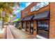 Charming brick buildings featuring a real estate office and a pizza shop line a vibrant city street at 2601 Boulder Way, Woodstock, GA 30188