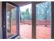 View of the deck through open glass doors with wood flooring leading to a red stained deck at 541 Exam Ct, Lawrenceville, GA 30044