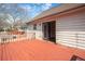 Exterior back deck showing stained wood, a white home, and a blue tinted window at 541 Exam Ct, Lawrenceville, GA 30044