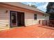 Exterior back deck shows open glass doors leading into home with stained wood at 541 Exam Ct, Lawrenceville, GA 30044