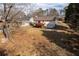 Backyard of a home with a red painted deck, wooden stairs, and a two car garage at 541 Exam Ct, Lawrenceville, GA 30044