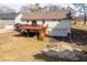 A view of the house's backyard, showcasing a wooden deck, lower-level access, and an attached garage at 541 Exam Ct, Lawrenceville, GA 30044