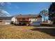 Backyard view of a two-story house, featuring a deck, lawn, and an attached garage at 541 Exam Ct, Lawrenceville, GA 30044