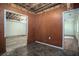 Unfinished basement area featuring paneled walls and a doorway leading to another room at 541 Exam Ct, Lawrenceville, GA 30044