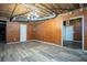 Unfinished basement shows wood paneling, exposed beams, and flooring at 541 Exam Ct, Lawrenceville, GA 30044