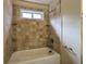 Tiled tub and shower combo with window and built in shelves at 541 Exam Ct, Lawrenceville, GA 30044