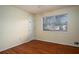 Bright bedroom featuring hardwood floors and a large window at 541 Exam Ct, Lawrenceville, GA 30044