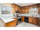 Well-lit kitchen with granite countertops, stainless steel appliances, and wood cabinets at 541 Exam Ct, Lawrenceville, GA 30044