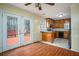 Cozy kitchen with wood cabinets, island, double doors leading to the deck at 541 Exam Ct, Lawrenceville, GA 30044