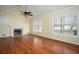 Large living room with hardwood floors, a fireplace, and large windows with wooded views at 541 Exam Ct, Lawrenceville, GA 30044